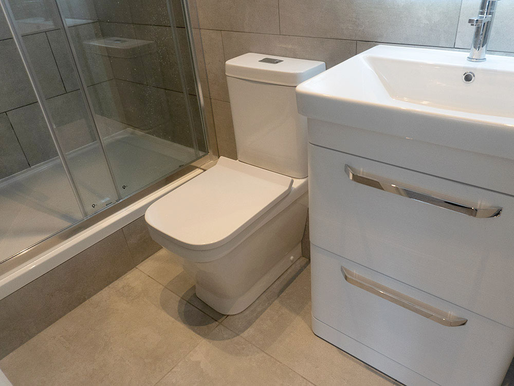 Modern Bathroom installation with shower, basin, toilet and bluetooth mirror